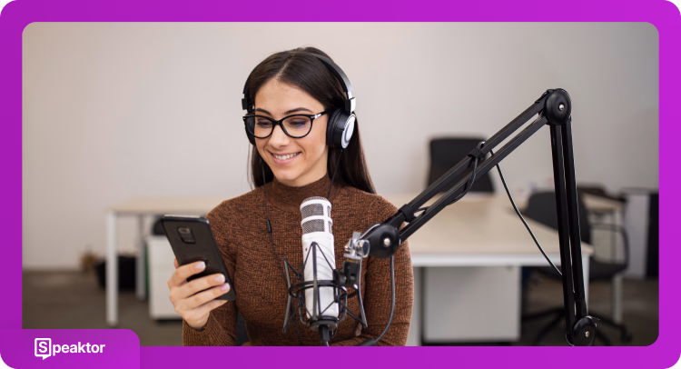 Woman with glasses and headphones recording podcast with professional microphone equipment in studio